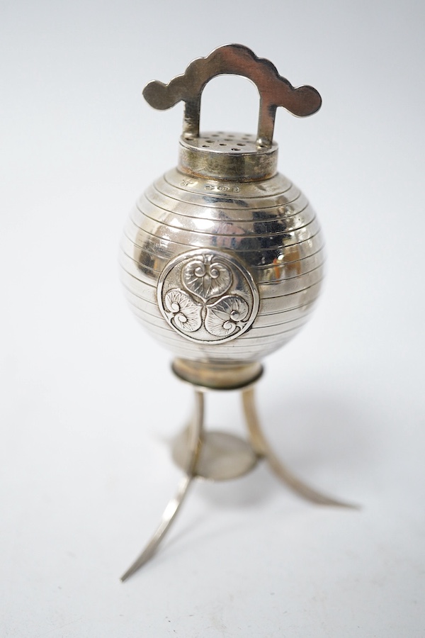 A Georgian silver mounted cut glass caster, London, 1818, 15.7cm, together with a Japanese silver condiment on tripod supports, import marks for Harrods Ltd, London, 1920. Condition - poor to fair